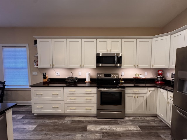 kitchen with appliances with stainless steel finishes, white cabinets, dark wood-type flooring, and open shelves