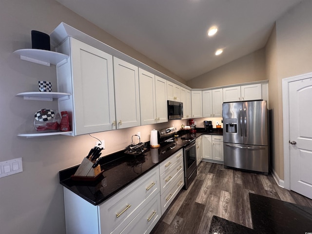 kitchen featuring dark wood-style floors, dark countertops, lofted ceiling, appliances with stainless steel finishes, and white cabinets