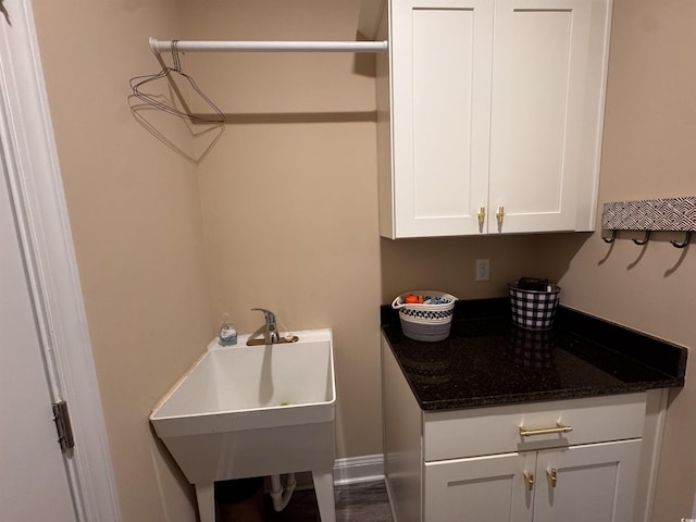 washroom featuring a sink and baseboards