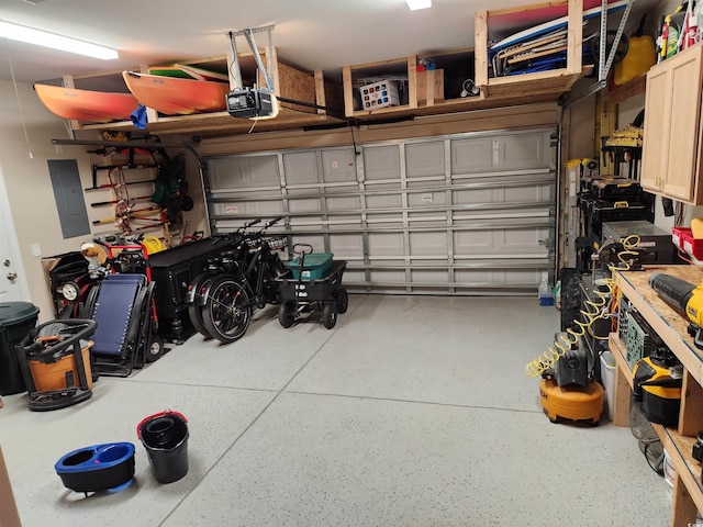 garage featuring electric panel and a garage door opener