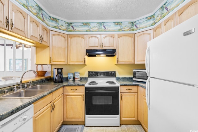 kitchen featuring a textured ceiling, light brown cabinetry, sink, and white appliances