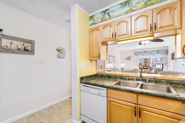 kitchen with dishwasher, sink, wood walls, pendant lighting, and a textured ceiling