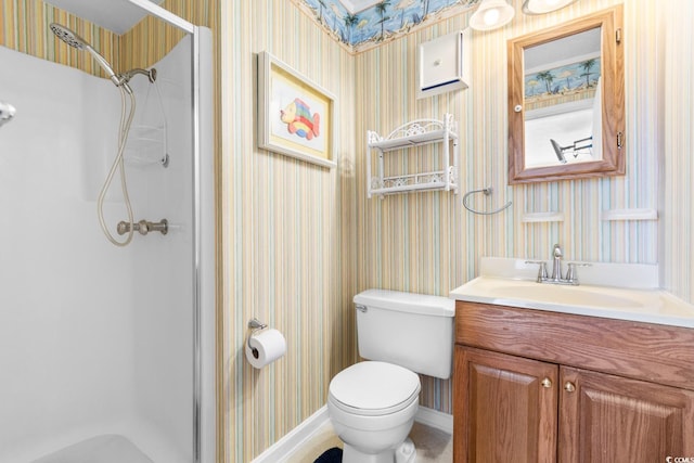 bathroom with vanity, toilet, and a shower