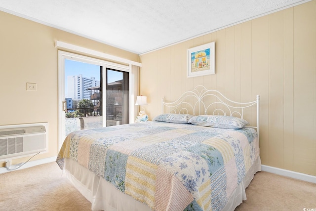 bedroom featuring access to exterior, carpet floors, ornamental molding, and a wall unit AC