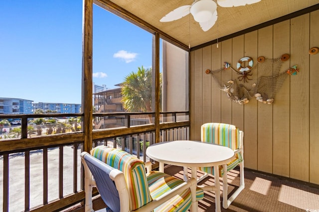 sunroom / solarium featuring plenty of natural light and ceiling fan