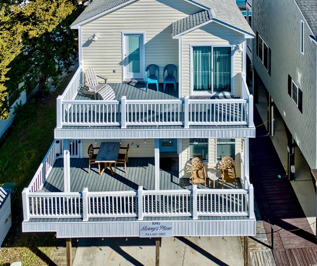 rear view of house with a balcony, central AC unit, a patio area, and a wooden deck