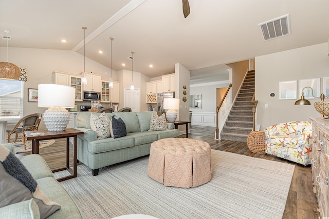 living room with hardwood / wood-style floors and lofted ceiling