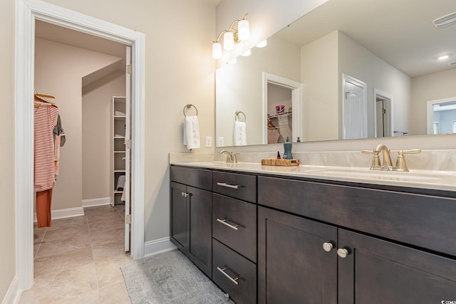 bathroom featuring tile patterned flooring and vanity