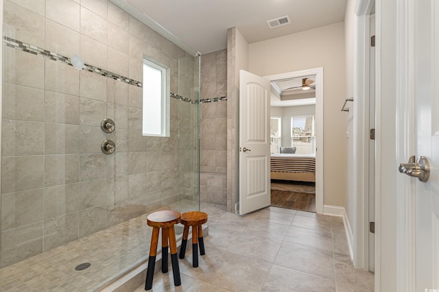 bathroom with a tile shower and tile patterned floors