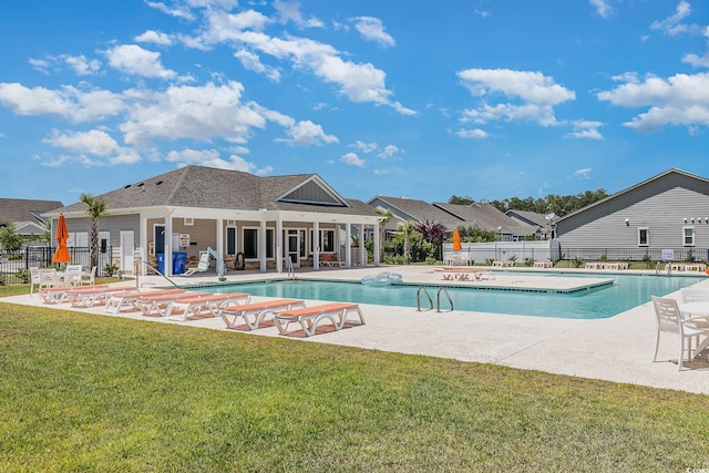 view of pool with a yard and a patio