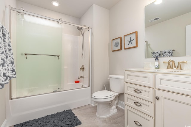 full bathroom with tile patterned floors, vanity, bath / shower combo with glass door, and toilet