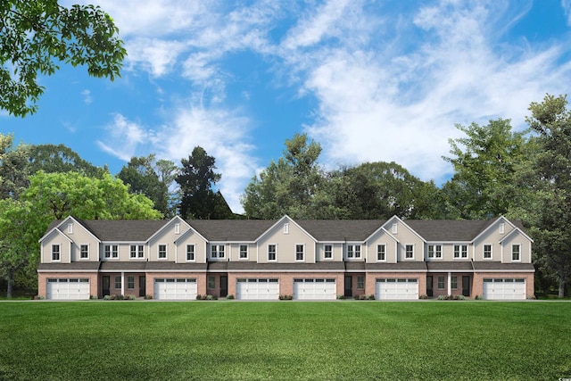 view of property featuring a front lawn and brick siding