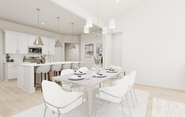 dining room with light wood-style flooring, baseboards, and recessed lighting