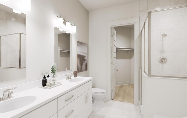 full bath with double vanity, a stall shower, toilet, and a sink