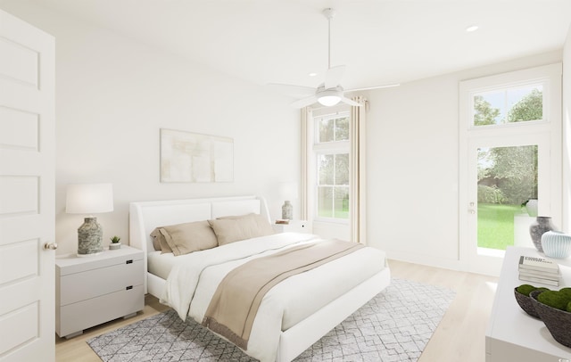 bedroom with multiple windows, ceiling fan, and light wood finished floors