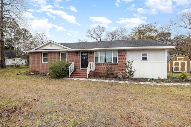 ranch-style home with a storage shed and a front yard