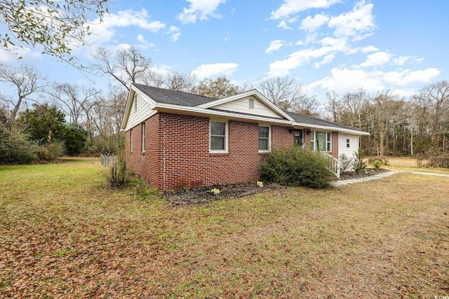 view of side of property featuring a yard