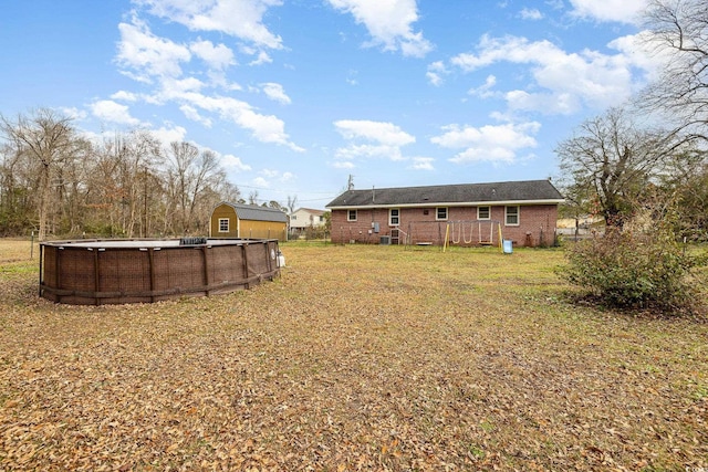 view of yard with a swimming pool side deck and a shed