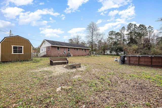 view of yard with a playground and a shed