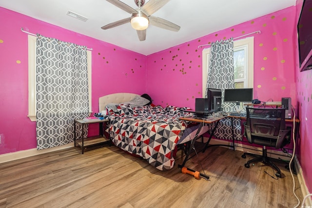 bedroom with hardwood / wood-style floors and ceiling fan