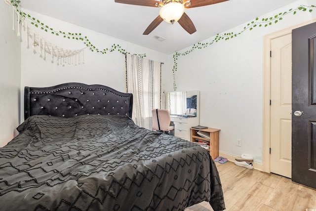 bedroom with light hardwood / wood-style floors and ceiling fan