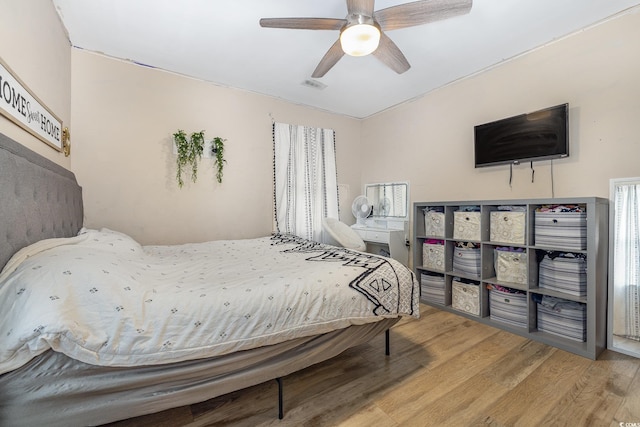 bedroom with hardwood / wood-style flooring and ceiling fan