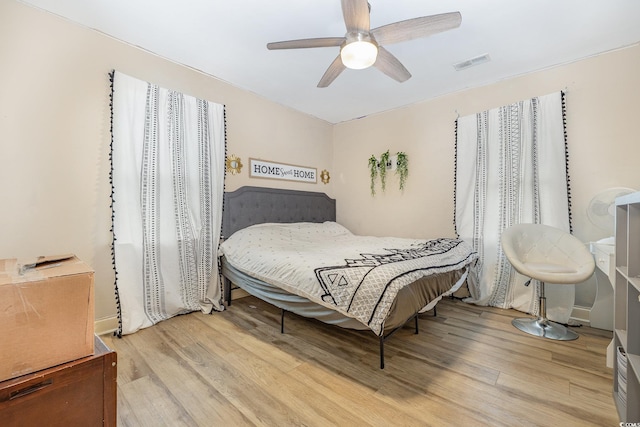 bedroom with ceiling fan and light wood-type flooring