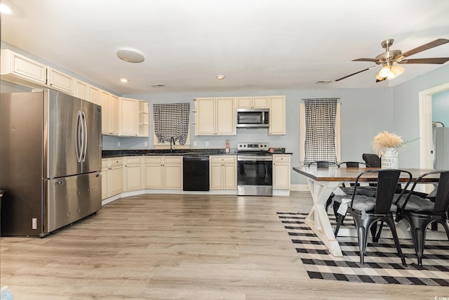 kitchen featuring light hardwood / wood-style floors, sink, appliances with stainless steel finishes, and cream cabinets