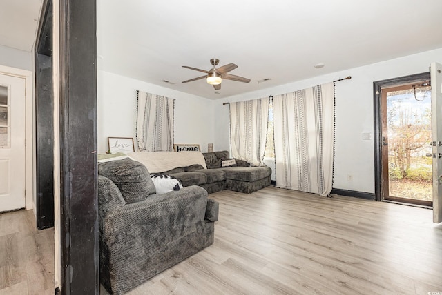 living room with ceiling fan and light hardwood / wood-style floors