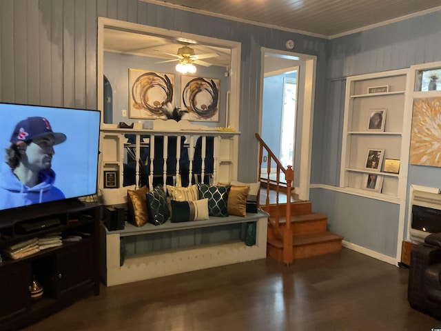 living room with ceiling fan and ornamental molding