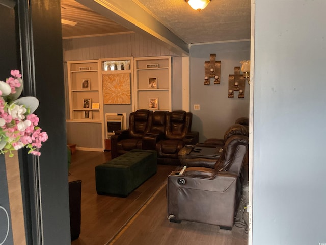 living room featuring beamed ceiling, hardwood / wood-style floors, a textured ceiling, and crown molding