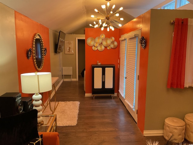 hallway with vaulted ceiling, french doors, dark hardwood / wood-style floors, and an inviting chandelier