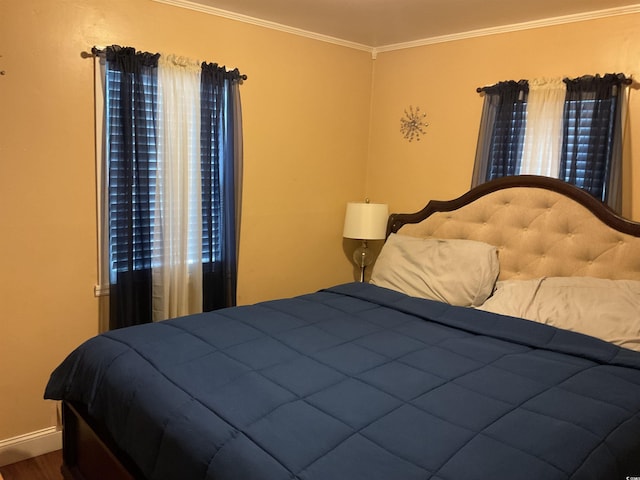 bedroom featuring hardwood / wood-style floors and ornamental molding