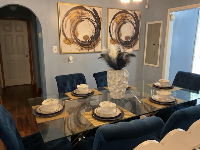 dining area with wood-type flooring and electric panel