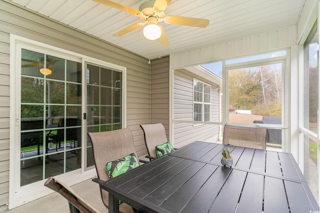 sunroom / solarium featuring ceiling fan