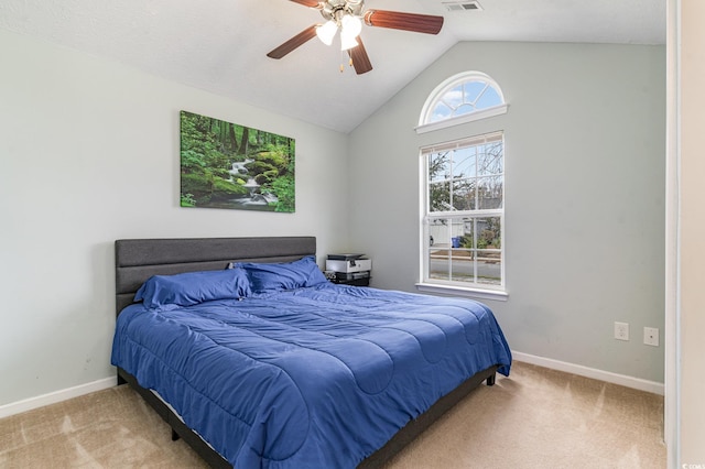 bedroom with ceiling fan, light carpet, and vaulted ceiling