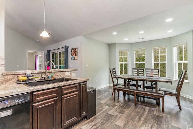 kitchen with dark brown cabinets, sink, decorative light fixtures, black dishwasher, and dark hardwood / wood-style floors