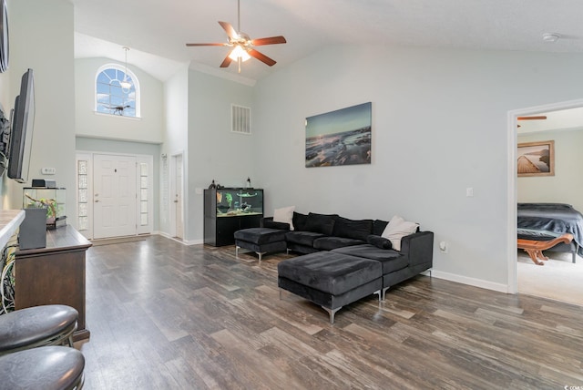 living room featuring ceiling fan, dark hardwood / wood-style flooring, and high vaulted ceiling