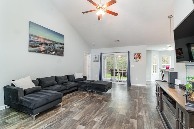 living room with ceiling fan, dark wood-type flooring, and high vaulted ceiling