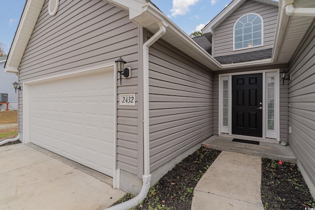 doorway to property featuring a garage