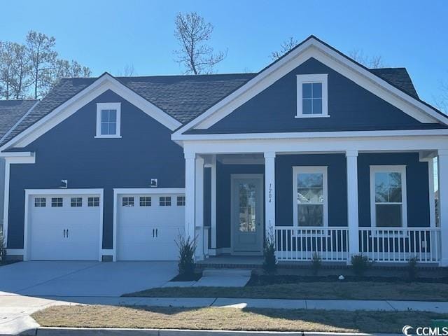 view of front of home featuring a porch and a garage