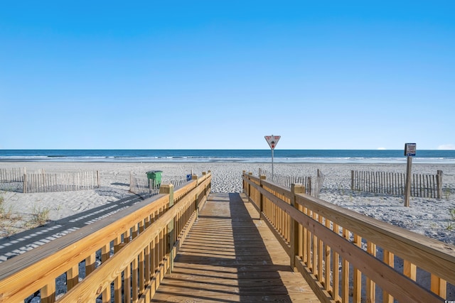 surrounding community with a view of the beach and a water view