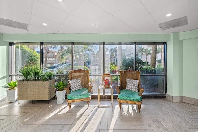 sunroom / solarium featuring a drop ceiling