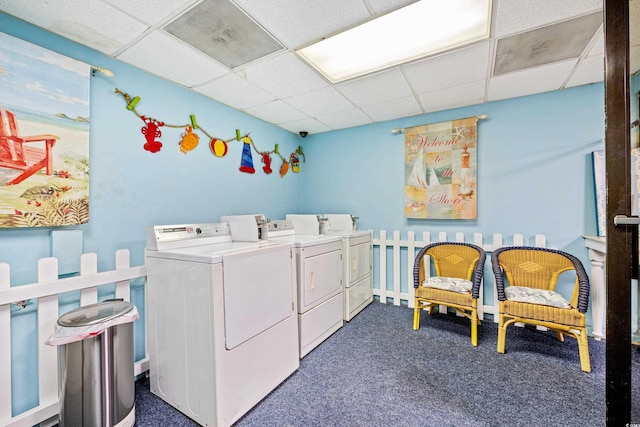 washroom with washing machine and clothes dryer and dark colored carpet