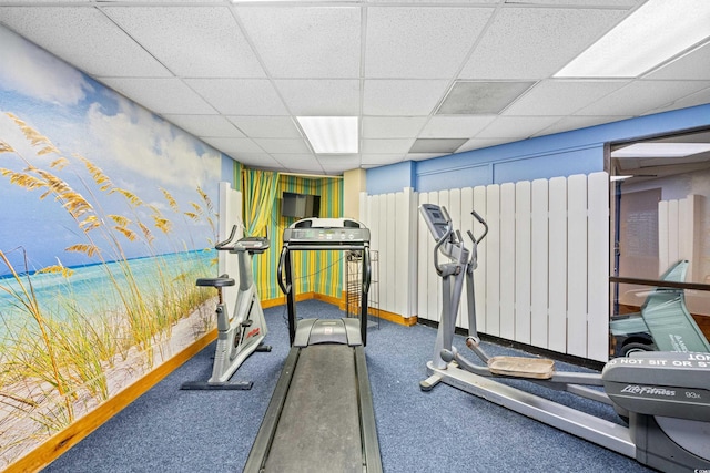 exercise room with a drop ceiling and radiator