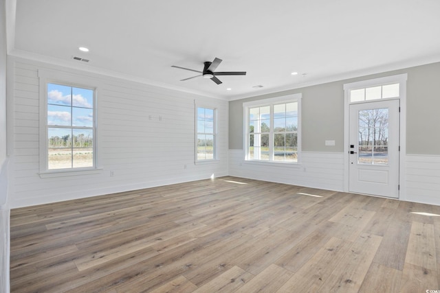 foyer with light wood-type flooring, ceiling fan, and ornamental molding