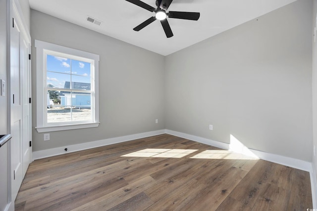 empty room featuring wood-type flooring and ceiling fan