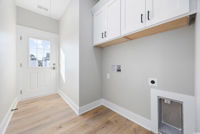 clothes washing area featuring electric dryer hookup, hookup for a washing machine, cabinets, and light hardwood / wood-style flooring