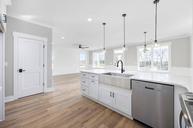 kitchen with sink, white cabinets, dishwasher, ceiling fan, and pendant lighting