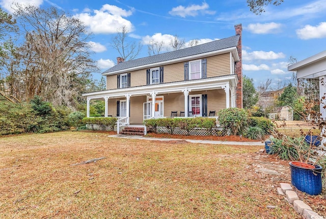 view of front of house with a porch and a front yard